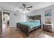 Primary bedroom boasts a ceiling fan and hardwood floors at 7418 Bay Dr, Tampa, FL 33635