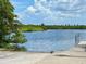 Scenic boat ramp offering easy access to the calm, blue water surrounded by lush greenery at 7418 Bay Dr, Tampa, FL 33635