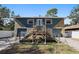 Charming two-story home with stone accents, double garages and an elevated entrance at 7418 Bay Dr, Tampa, FL 33635