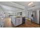 Open kitchen with granite island, stainless appliances, and hardwood floors at 7418 Bay Dr, Tampa, FL 33635