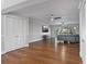 Spacious living room with hardwood floors, ceiling fans, and natural light at 7418 Bay Dr, Tampa, FL 33635