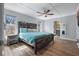 Comfortable bedroom with hardwood floors, a ceiling fan, and an ensuite bathroom at 7418 Bay Dr, Tampa, FL 33635