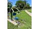 Outdoor gym equipment located in a green park setting with sidewalk access at 7418 Bay Dr, Tampa, FL 33635