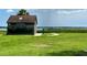 Small building with a restroom, located in a grassy park area near the water at 7418 Bay Dr, Tampa, FL 33635