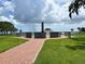 Veterans memorial surrounded by well-manicured green lawns, walkways and views of the bay at 7418 Bay Dr, Tampa, FL 33635