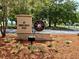 Park sign on Shore Drive West with well-kept landscaping and water views in the background at 7418 Bay Dr, Tampa, FL 33635