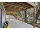 Covered patio area showing stairs, beams, supports, and a table for enjoying the outdoors at 7418 Bay Dr, Tampa, FL 33635