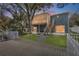 Back of house featuring a deck, large screened in porch and spacious backyard at 7418 Bay Dr, Tampa, FL 33635