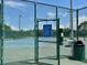 City of Oldsmar tennis court rules posted outside fenced tennis courts, providing a community recreational amenity at 7418 Bay Dr, Tampa, FL 33635