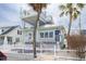 Inviting coastal home featuring a private roof deck, quaint front porch and white picket fence at 106 7Th Ave, St Pete Beach, FL 33706