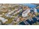 A sunny aerial view showcases a neighborhood with waterfront views, a marina, and nearby buildings at 1330 Snell Isle Ne Blvd # 4, St Petersburg, FL 33704