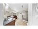 Spacious bathroom with a whirlpool tub, walk-in shower, dual vanities, and tile flooring at 443 Pinellas Bayway S # 105, Tierra Verde, FL 33715