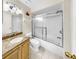 Bright bathroom with a vanity, granite countertop, and a glass-enclosed shower/tub combination at 443 Pinellas Bayway S # 105, Tierra Verde, FL 33715