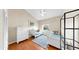 Bright bedroom with hardwood floors, a window, and twin beds with matching white furniture at 443 Pinellas Bayway S # 105, Tierra Verde, FL 33715