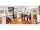 Bright dining room featuring wood floors, spiral staircase access, and a view into the kitchen at 443 Pinellas Bayway S # 105, Tierra Verde, FL 33715