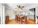 Open dining room with wood floors, ceiling fan, access to the kitchen and a beautiful spiral staircase at 443 Pinellas Bayway S # 105, Tierra Verde, FL 33715