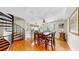An open-concept dining room featuring a spiral staircase, wood floors, and views of the kitchen at 443 Pinellas Bayway S # 105, Tierra Verde, FL 33715