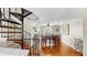 Open dining area with wood floors, ceiling fan, and spiral staircase at 443 Pinellas Bayway S # 105, Tierra Verde, FL 33715