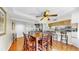 Spacious dining area with a wooden table and chairs, wood floors, ceiling fan and a view into the kitchen at 443 Pinellas Bayway S # 105, Tierra Verde, FL 33715