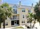 Exterior of home with balconies and palm trees, highlighting the architecture and landscaping at 443 Pinellas Bayway S # 105, Tierra Verde, FL 33715