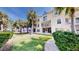 Charming condo with well-maintained lawn and mature palm trees enhancing the curb appeal at 443 Pinellas Bayway S # 105, Tierra Verde, FL 33715