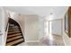 Inviting foyer featuring tile flooring, staircase and front door at 443 Pinellas Bayway S # 105, Tierra Verde, FL 33715