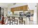 Open kitchen features stainless appliances, breakfast bar with stools, and stone backsplash at 443 Pinellas Bayway S # 105, Tierra Verde, FL 33715