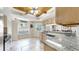 Bright eat-in kitchen with granite countertops, updated appliances, and custom tile flooring at 443 Pinellas Bayway S # 105, Tierra Verde, FL 33715