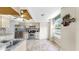 Bright kitchen with stainless steel appliances, granite countertops, light wood cabinets, tile flooring and a window at 443 Pinellas Bayway S # 105, Tierra Verde, FL 33715