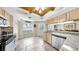 Bright kitchen with tile floors, granite countertops, and modern appliances at 443 Pinellas Bayway S # 105, Tierra Verde, FL 33715