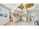 Well-appointed eat-in kitchen featuring granite counters, wood cabinets, and mosaic backsplash at 443 Pinellas Bayway S # 105, Tierra Verde, FL 33715