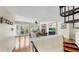 Bright living room with wood floors, fireplace, French doors to the outside, and spiral staircase access at 443 Pinellas Bayway S # 105, Tierra Verde, FL 33715