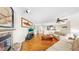 Open concept living room featuring a fireplace and wood flooring at 443 Pinellas Bayway S # 105, Tierra Verde, FL 33715