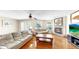 Cozy living room with a fireplace, comfortable seating, and hardwood floors at 443 Pinellas Bayway S # 105, Tierra Verde, FL 33715