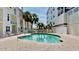Inviting community pool surrounded by lounge chairs, perfect for relaxation at 443 Pinellas Bayway S # 105, Tierra Verde, FL 33715