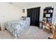 Cozy bedroom with a patterned bedspread, black curtains, and a bookshelf filled with games at 764 Captiva Ne Ct, St Petersburg, FL 33702