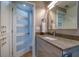 Modern bathroom with a sleek vanity, stylish fixtures, and frosted glass door detail at 8565 W Gulf Blvd # 17S, Treasure Island, FL 33706