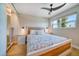 Bedroom featuring a ceiling fan, window views, and spacious closet, providing comfort and ample storage at 8565 W Gulf Blvd # 17S, Treasure Island, FL 33706