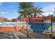 Welcome to Sunset Cove Condominiums, featuring a community pool, palm trees and tiki umbrellas for shade at 8565 W Gulf Blvd # 17S, Treasure Island, FL 33706