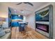Modern living space featuring a sleek kitchen, island seating, and electric fireplace with a mounted TV at 8565 W Gulf Blvd # 17S, Treasure Island, FL 33706