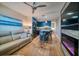 Stylish living area with a modern kitchen, island seating, and a cozy fireplace beneath a flatscreen TV at 8565 W Gulf Blvd # 17S, Treasure Island, FL 33706