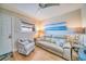 Comfortable living room features a plush sofa, accent chair, and charming decor at 8565 W Gulf Blvd # 17S, Treasure Island, FL 33706