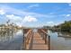Scenic view of a wooden pier, overlooking peaceful waters, inviting residents to enjoy waterfront living at 8565 W Gulf Blvd # 17S, Treasure Island, FL 33706