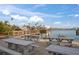 Waterfront view with picnic tables and wooden pier in the background providing recreational space for the community at 8565 W Gulf Blvd # 17S, Treasure Island, FL 33706