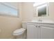 Bathroom with white vanity, square mirror, and ceramic toilet at 10118 Hickory Hill, Port Richey, FL 34668
