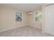 Bright bedroom features tile floors, two windows, fresh neutral paint, and closet space at 10118 Hickory Hill, Port Richey, FL 34668