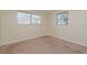 Comfortable bedroom featuring plush carpeting and two bright windows at 10118 Hickory Hill, Port Richey, FL 34668