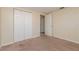 Well-lit bedroom with carpet flooring and large double closet doors at 10118 Hickory Hill, Port Richey, FL 34668