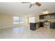 Open concept kitchen with dark cabinets, stainless steel appliances, granite counters, and tile flooring at 10118 Hickory Hill, Port Richey, FL 34668