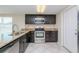 Modern kitchen with stainless steel appliances, granite countertops, and dark wood cabinetry at 10118 Hickory Hill, Port Richey, FL 34668